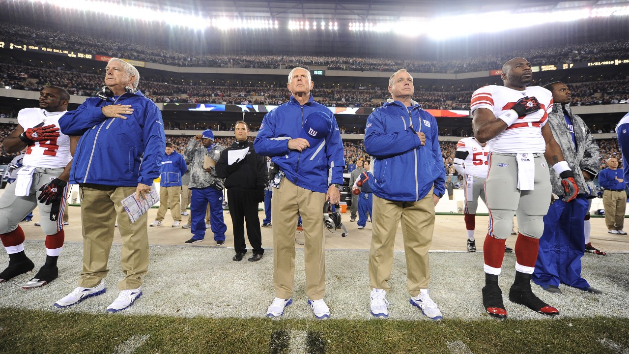 New York Giants head coach Tom Coughlin stands next to assistant coaches Mike Pope and Jerry Palmieri during the National Anthem before playing against the Philadelphia Eagles in a week 11 NFL football game at Lincoln Financial Field in Philadelphia, Pennsylvania on Sunday November 21, 2010 (AP Photo/Evan Pinkus)